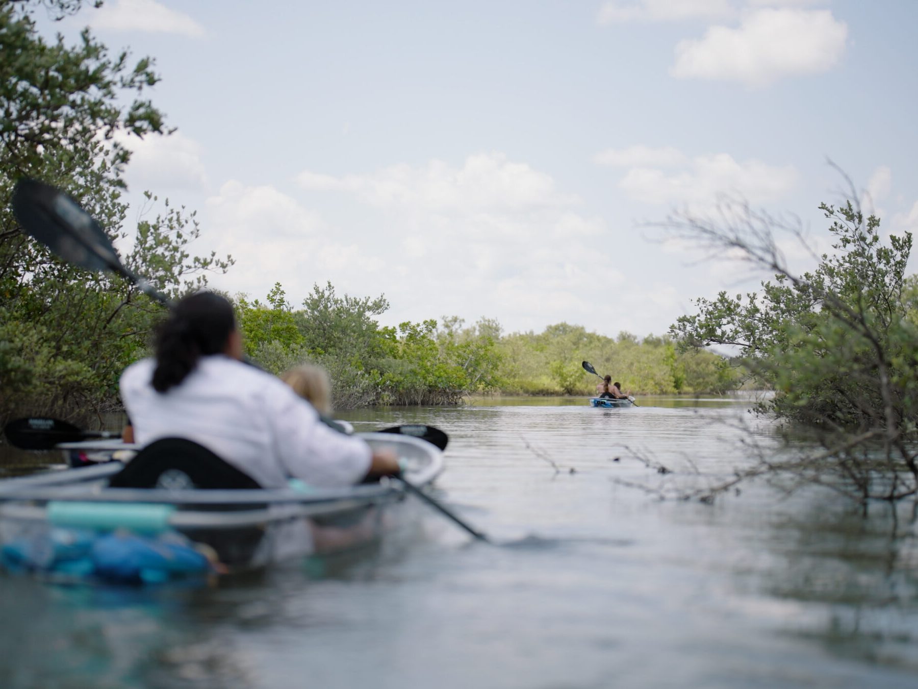 a man riding on the back of a boat in the water
