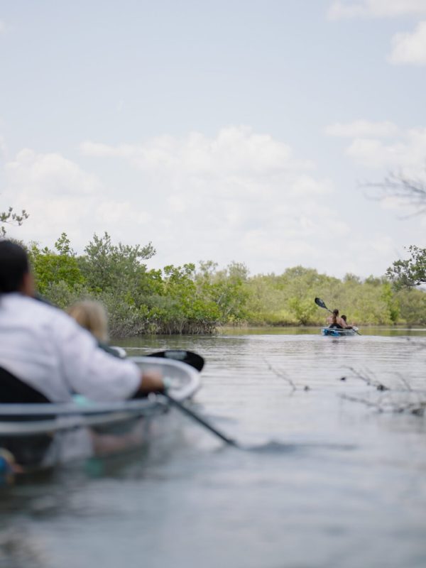 a man riding on the back of a boat in the water