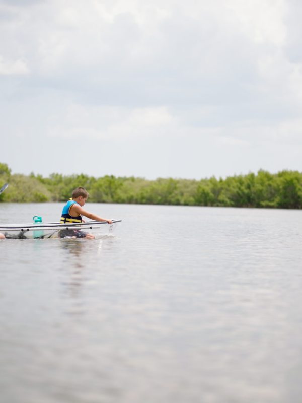 a group of people rowing a boat in a body of water