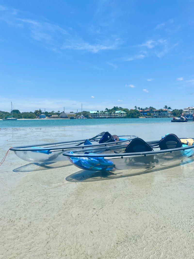 a blue boat sitting on top of a sandy beach