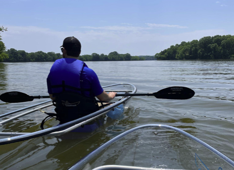 a group of people in a boat on a body of water