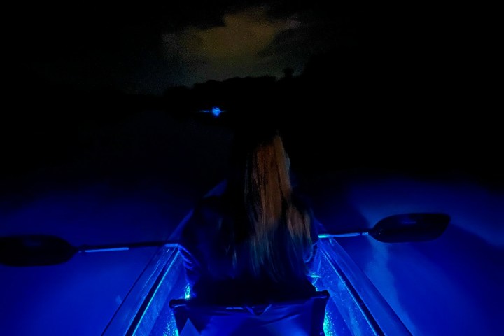 a close up of a light pole sitting in the dark