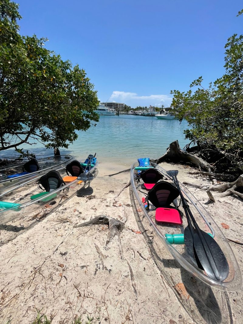 a boat sitting on top of a sandy beach