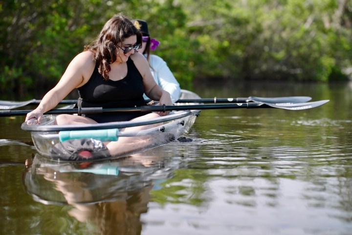 a woman sitting on a boat in the water