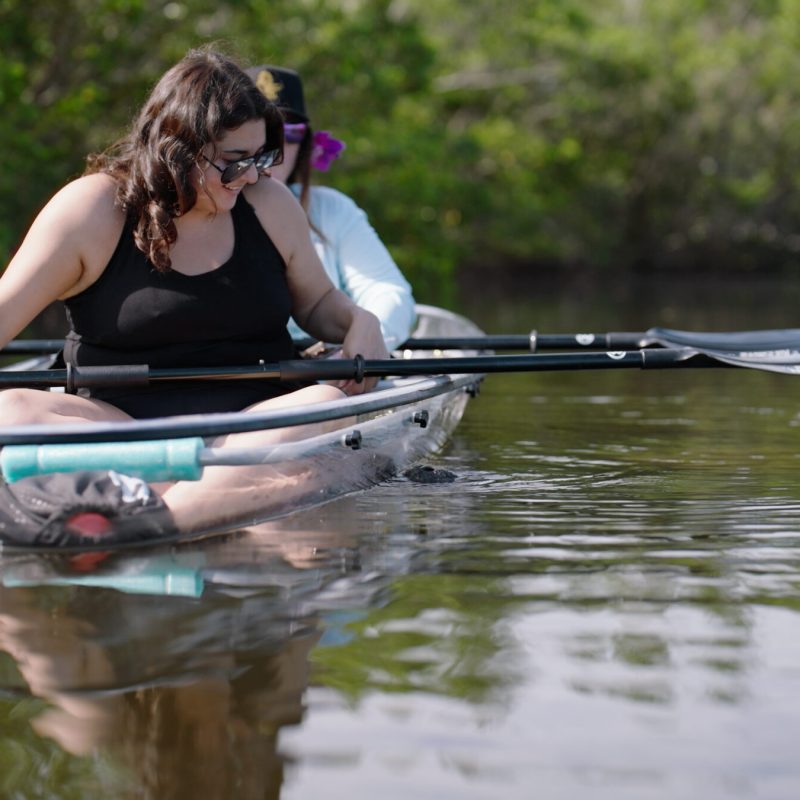 a woman sitting on a boat in the water