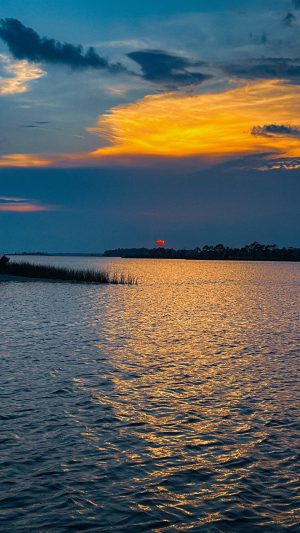 a sunset over a body of water