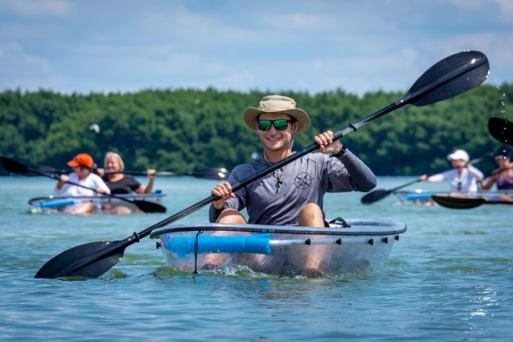 a group of people rowing a boat in the water