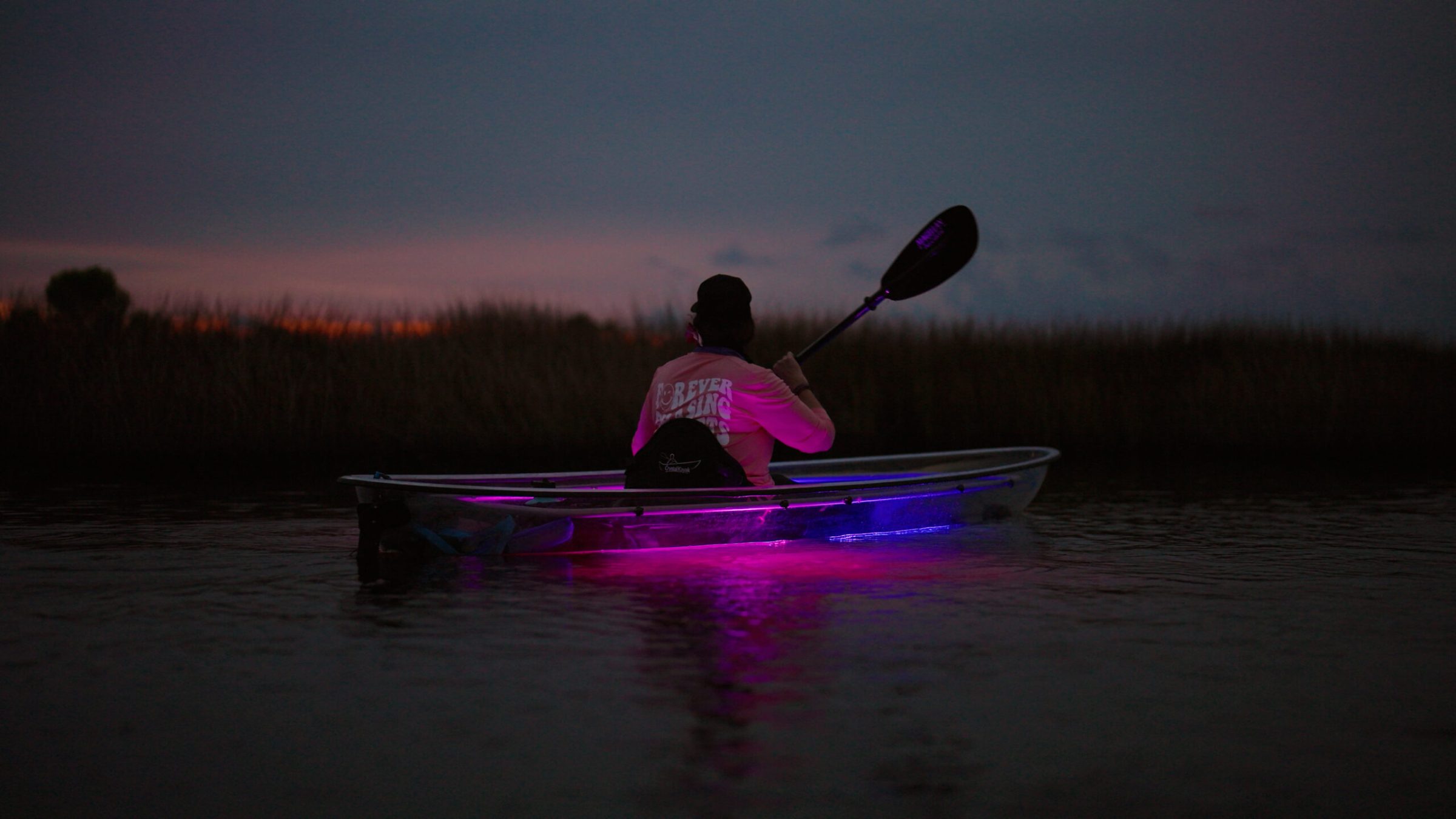 a man riding on the back of a boat in the water