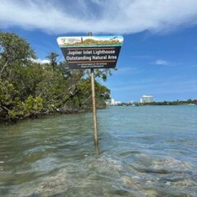 a sign above a body of water
