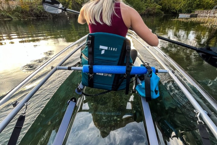 a person standing next to a body of water