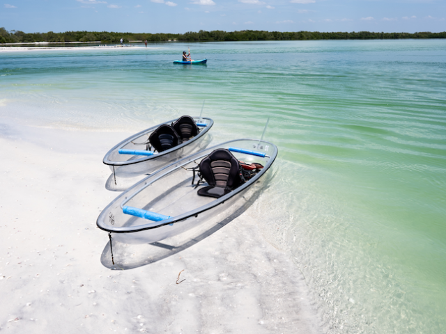 a boat on a beach near a body of water