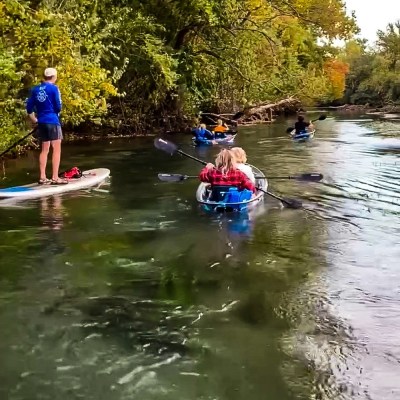a group of people riding on the back of a boat in the water