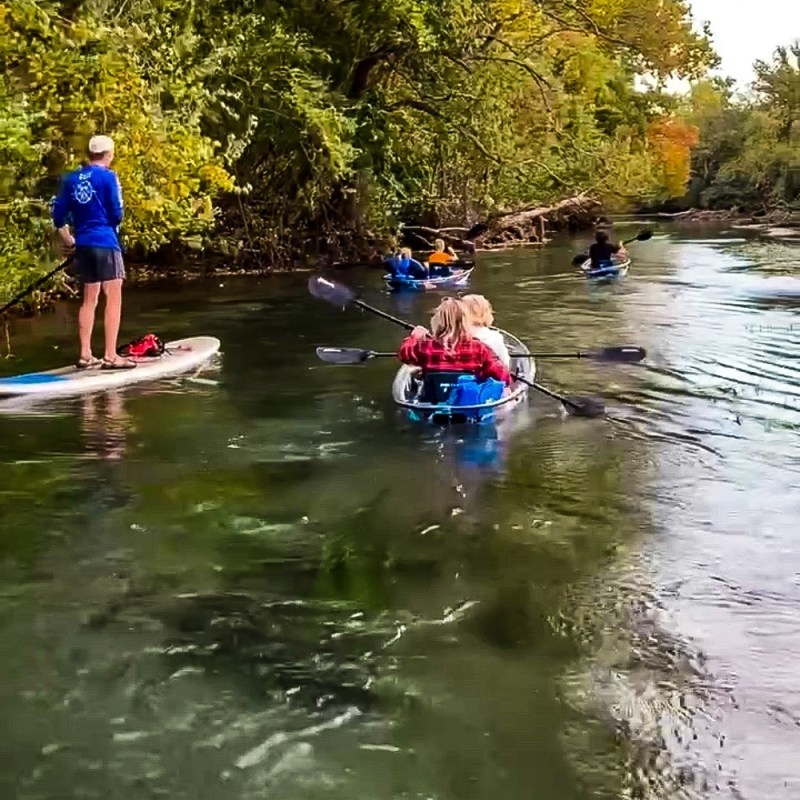 a group of people riding on the back of a boat in the water