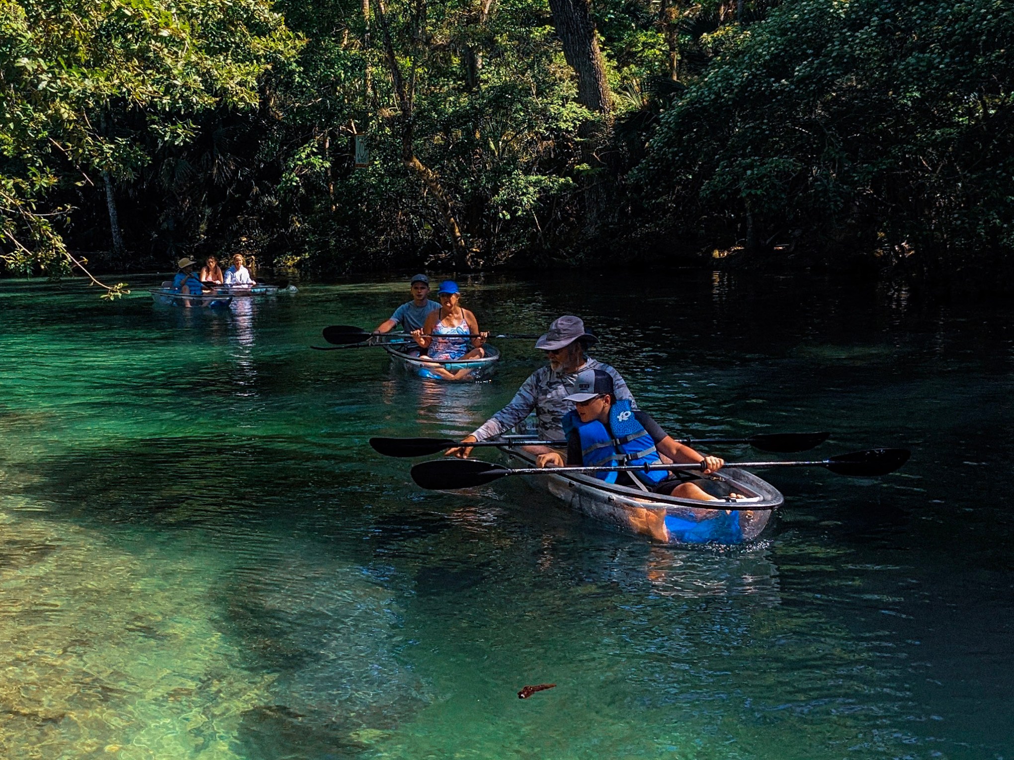 a group of people rowing a boat in the water