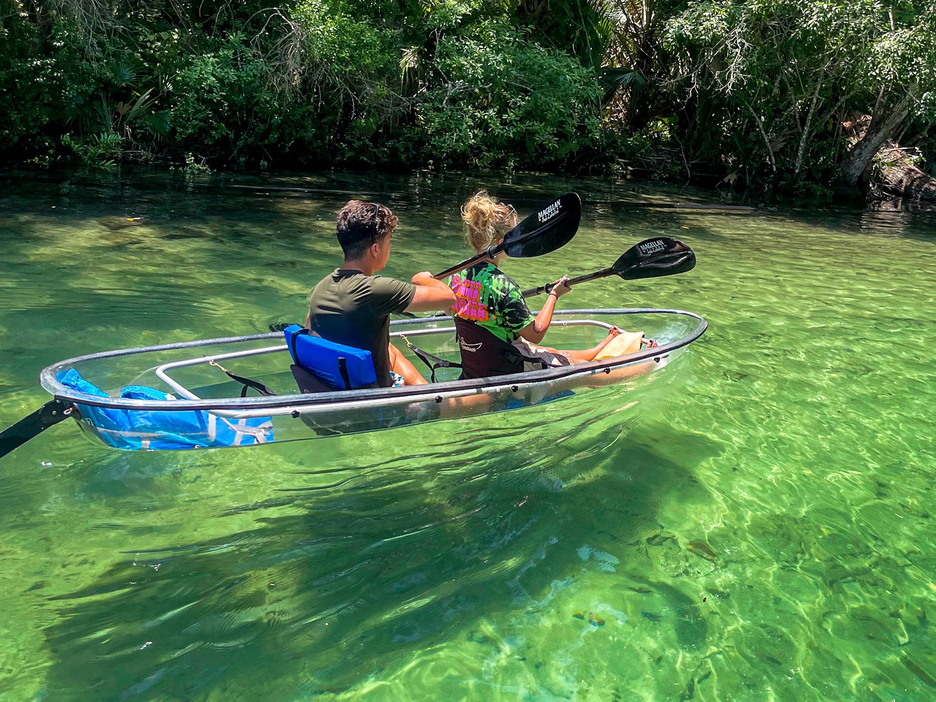 a person riding on the back of a boat in the water