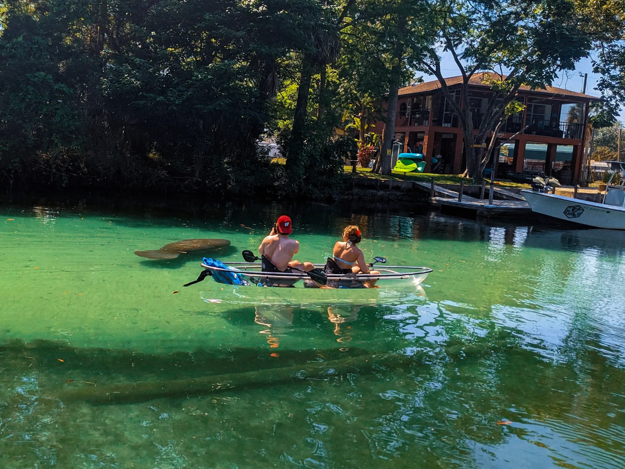 a group of people riding on the back of a boat in the water