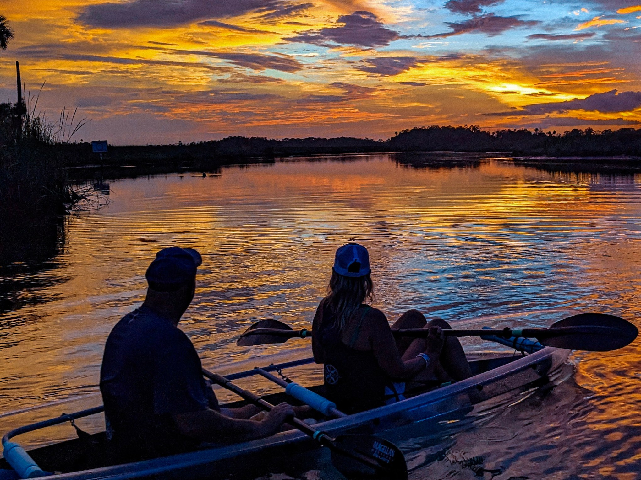 a group of people sitting on a raft in a body of water