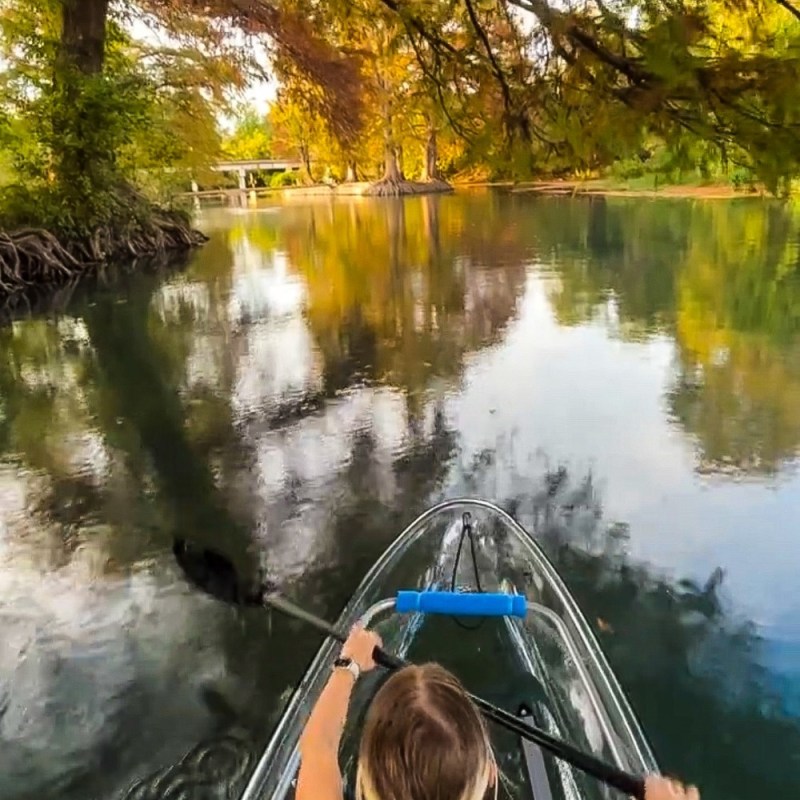 a person standing next to a body of water