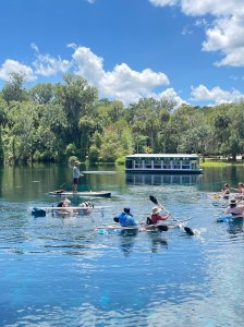 a group of people rowing a boat in the water