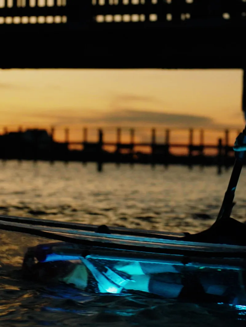a person sitting on a bench in front of a body of water