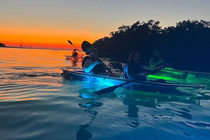 a man riding a surfboard on top of a body of water