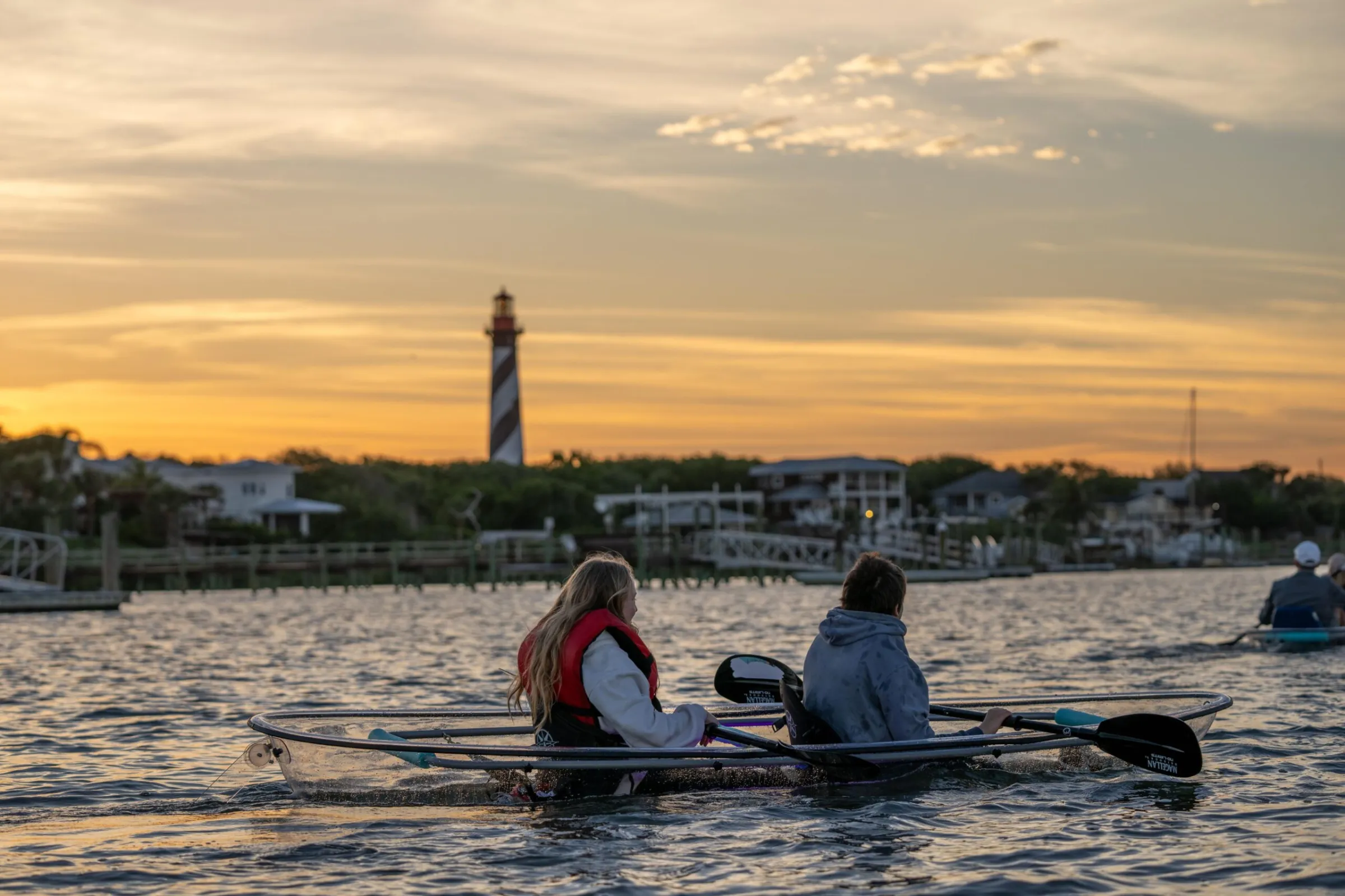 a group of people rowing a boat in a body of water