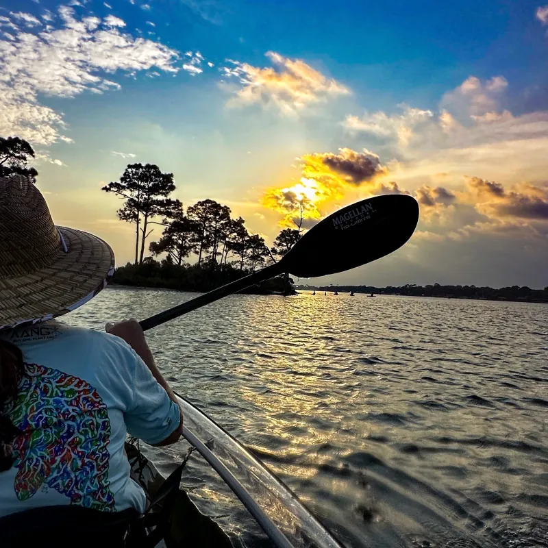 a person sitting next to a body of water