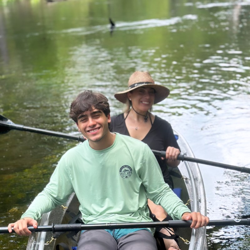 a group of people rowing a boat in the water