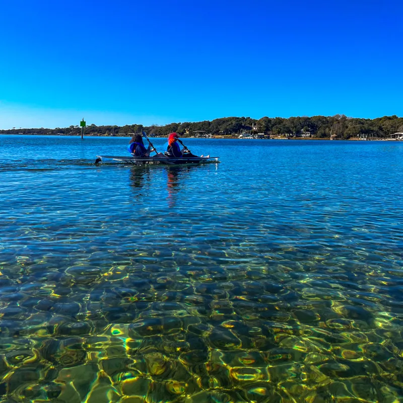 a blue frisbee sitting on top of a body of water