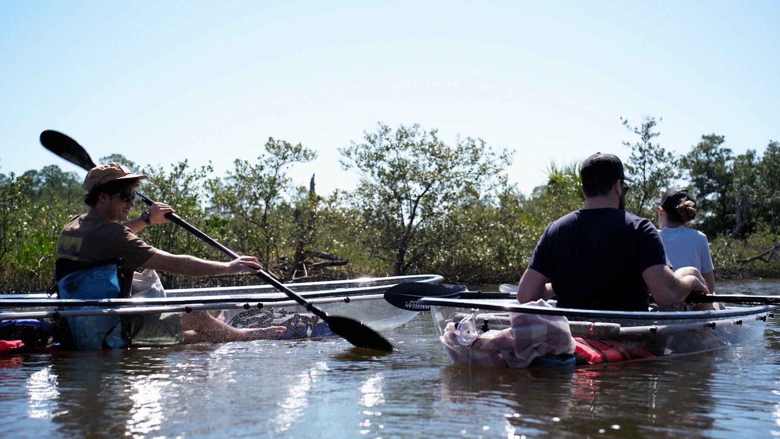 unnamed (80) a group of people rowing a boat in the water
