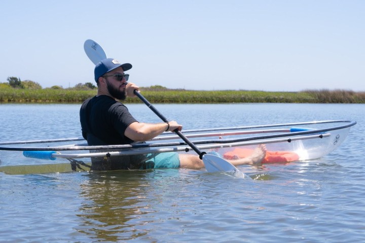 a man rowing a boat in a body of water