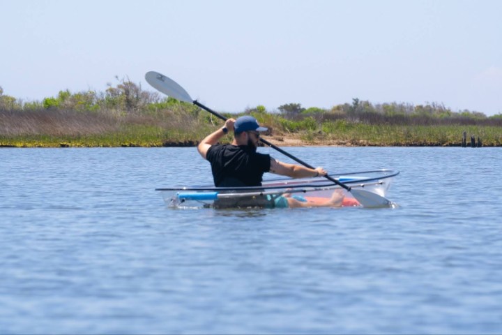 a man rowing a boat in a body of water