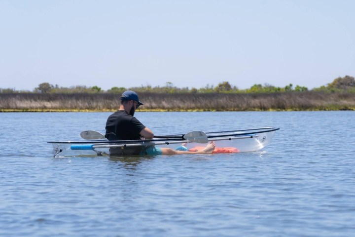 a man rowing a boat in a body of water