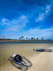 a boat sitting on top of a sandy beach