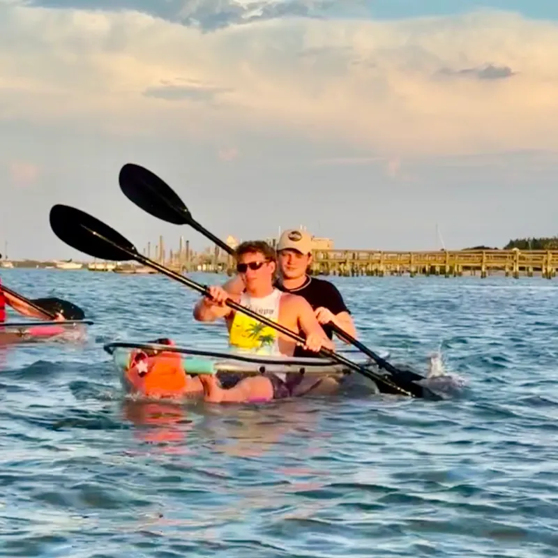 a group of people rowing a boat in the water