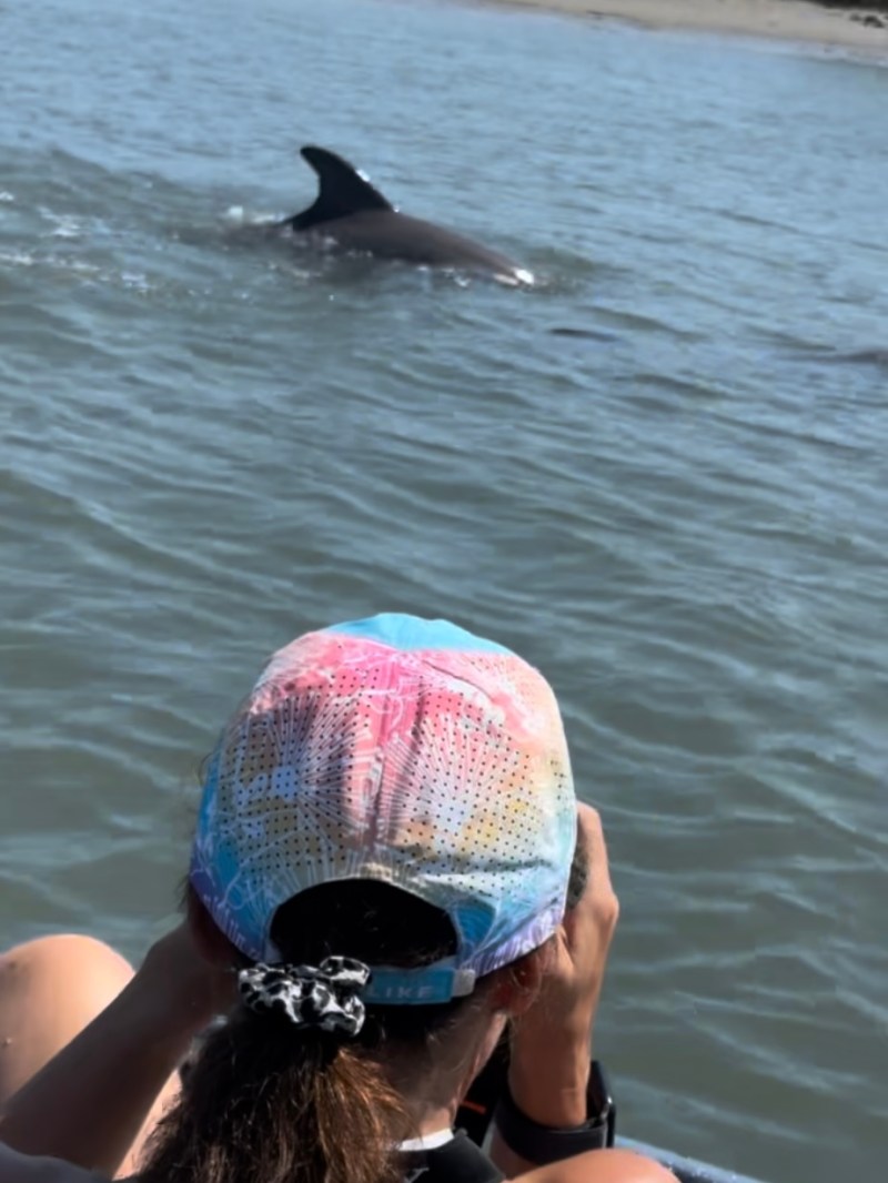 a woman swimming in a body of water