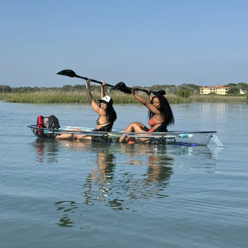 a group of people rowing a boat in a body of water