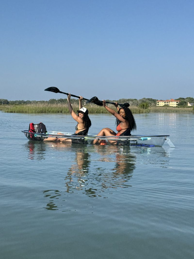a group of people rowing a boat in a body of water