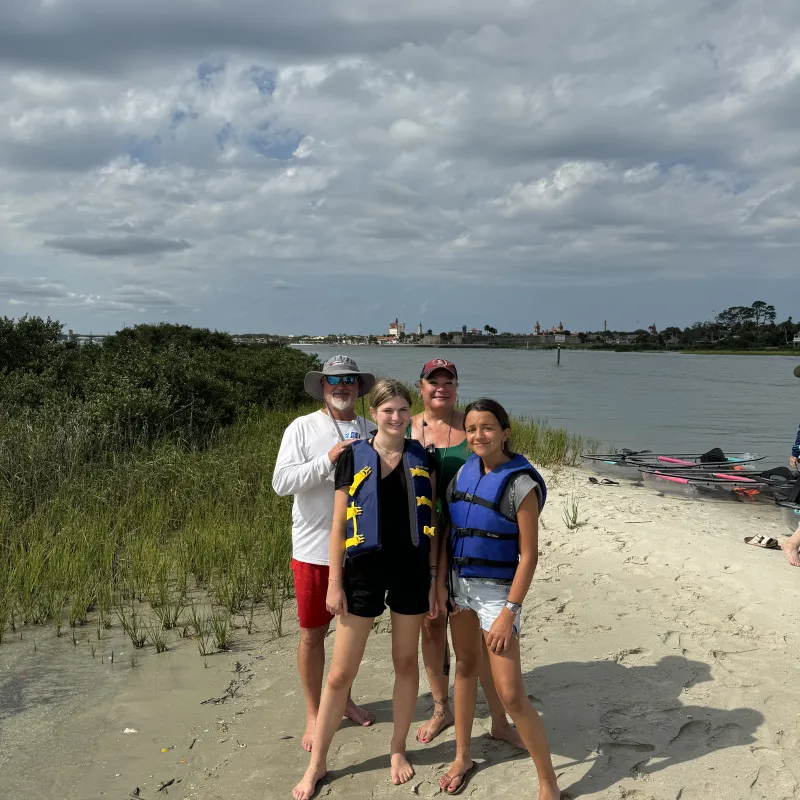 Elizabeth Rocha Salgado et al. standing on a beach