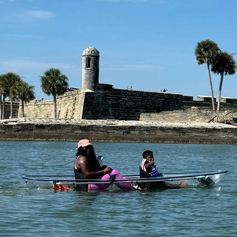a group of people rowing a boat in the water