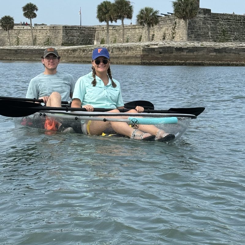 a group of people rowing a boat in the water