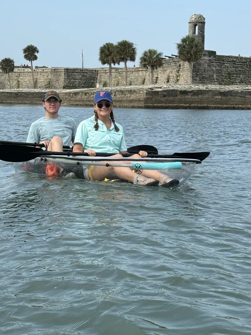 a group of people rowing a boat in the water