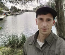 a man holding a fish in the water