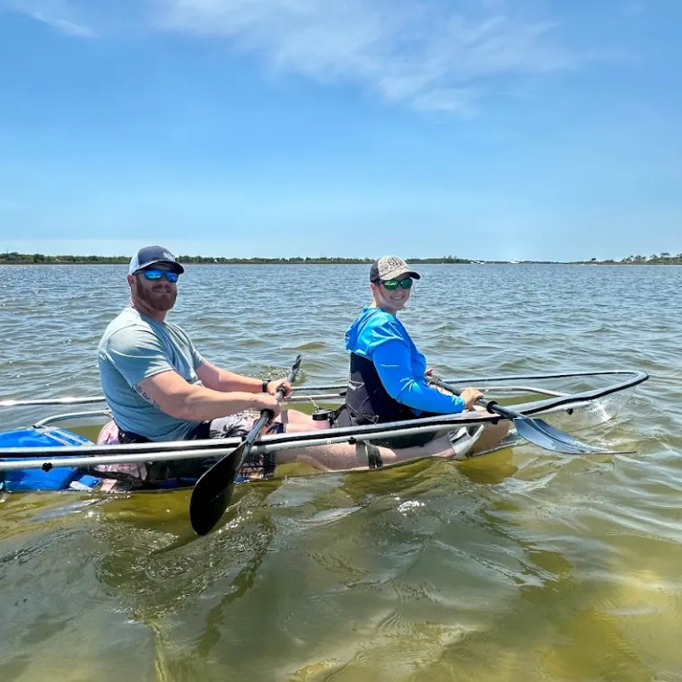 a man rowing a boat in a body of water