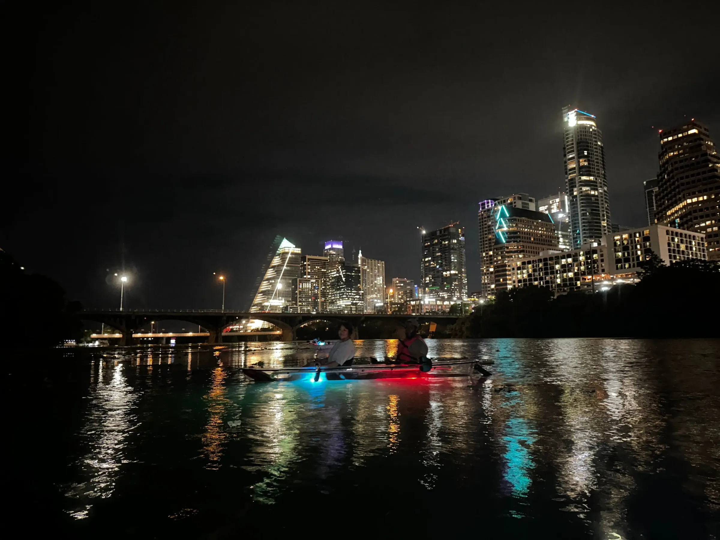 a large body of water with a city in the night sky