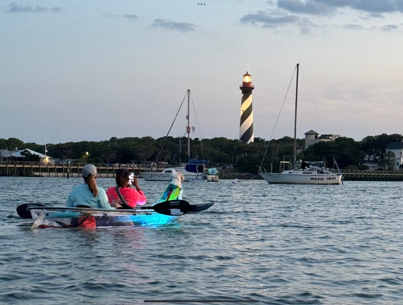 a group of people rowing a boat in the water