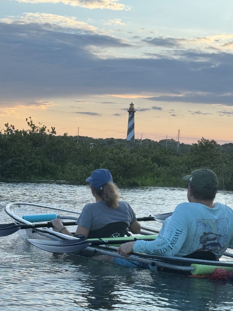 a group of people rowing a boat in the water