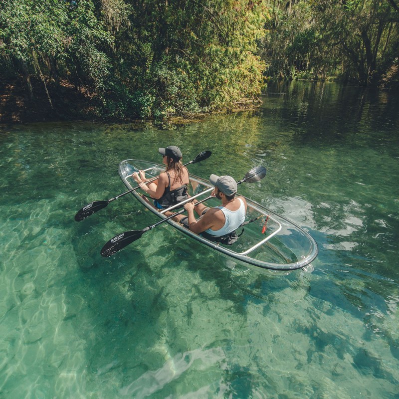 a man riding on the back of a boat in the water