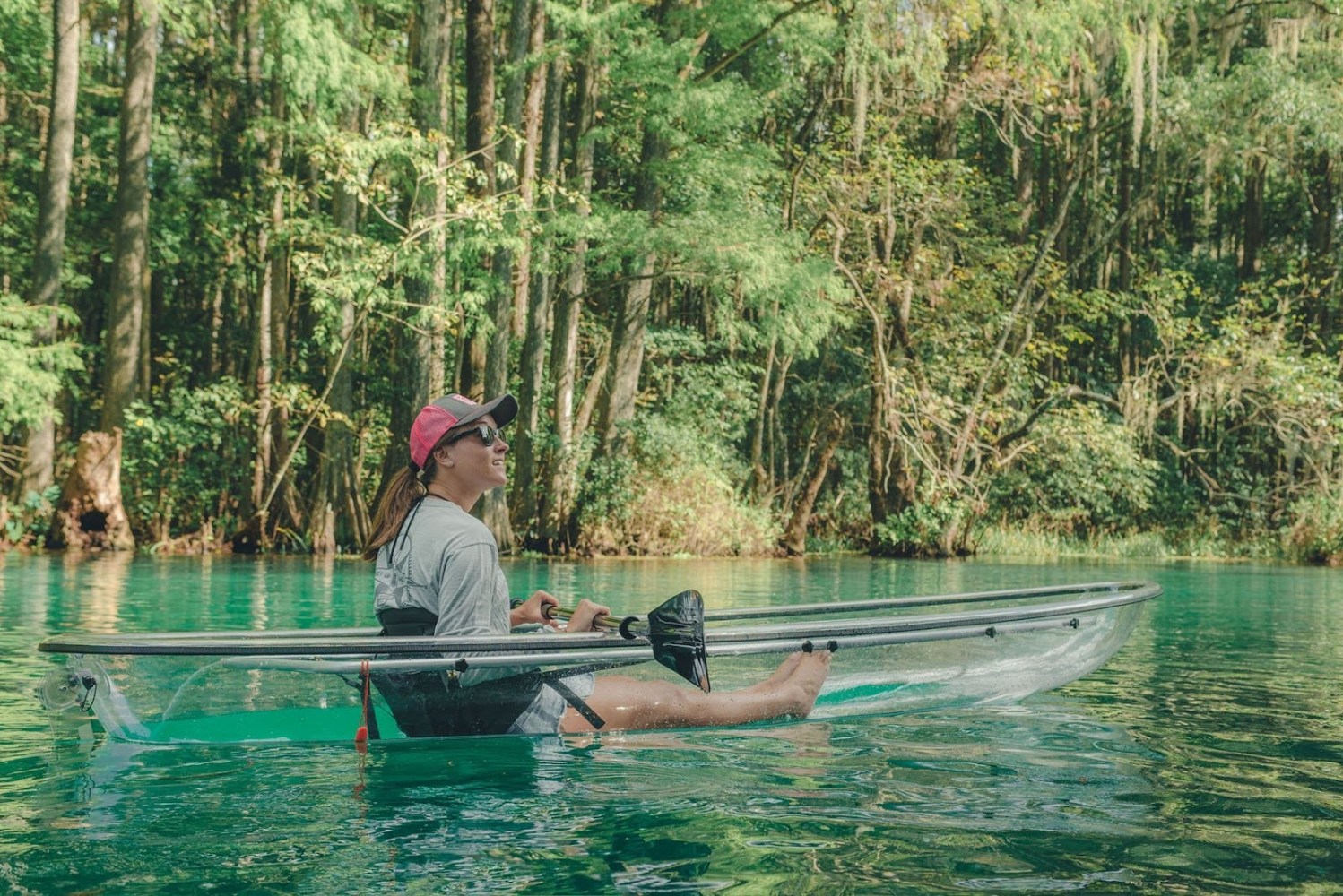 a man riding on the back of a boat in the water