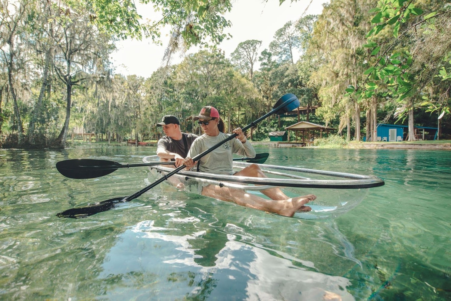 a group of people riding on the back of a boat in the water